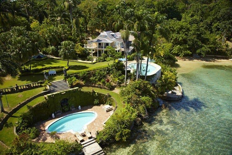 aerial view of large villa next to ocean