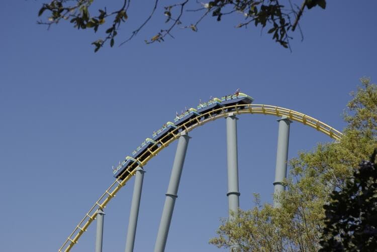 A roller coaster track with a car climbing to the top