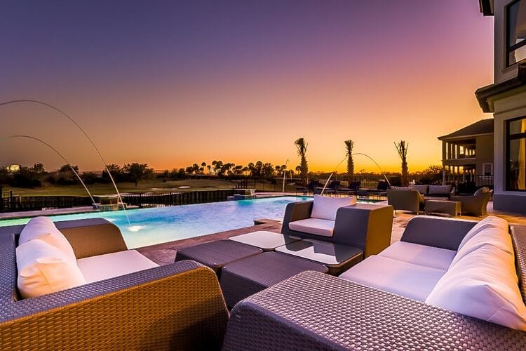 seating area and pool at dusk overlooking golf course