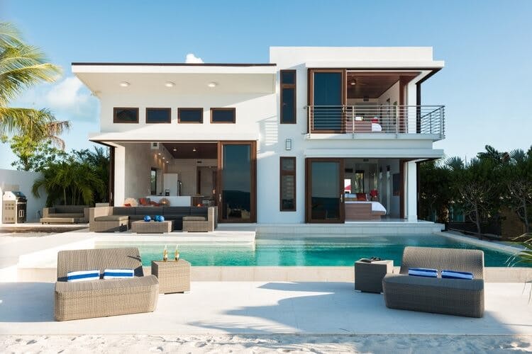 white villa with pool and loungers