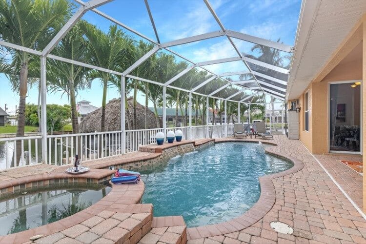 covered pool and hot tub on patio