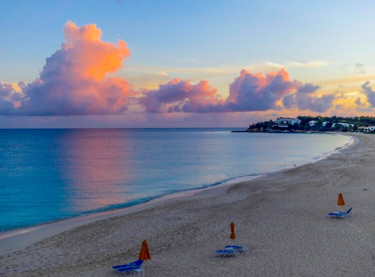 A pink-tinged sunrise over Meads Bay, Anguilla
