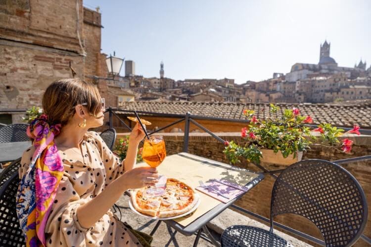 woman eating pizza in siena
