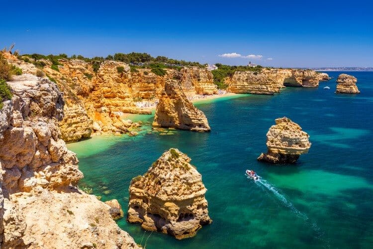 The dramatic rock formations in the ocean at Praia de Marinha