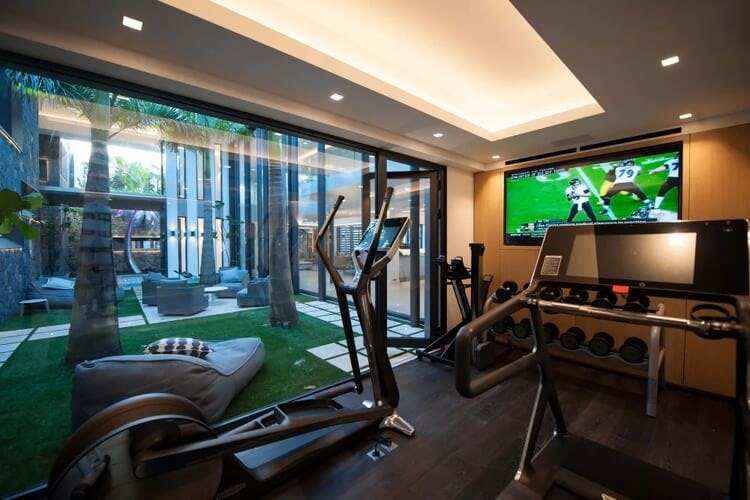 gym with exercise equipment and tv