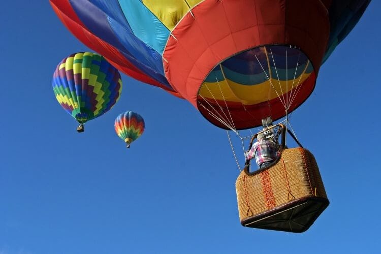Three colorful hot air balloons going up