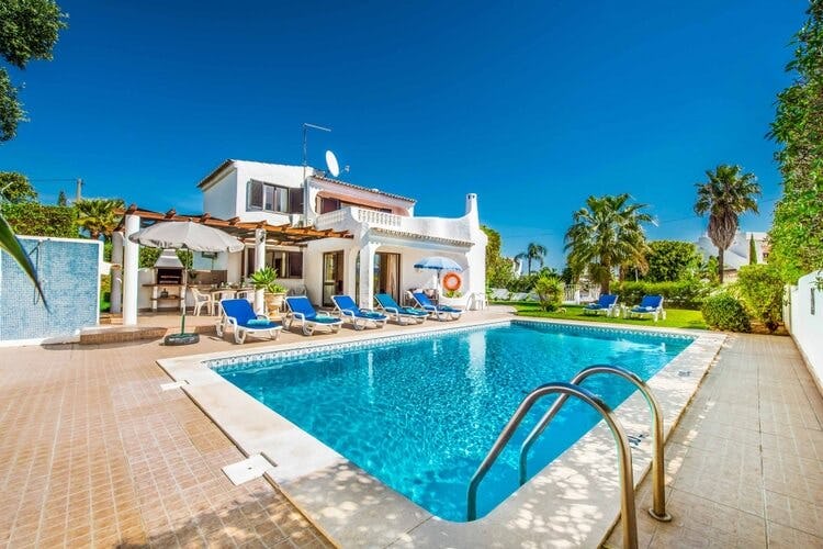 white villa with patio, pool and blue loungers
