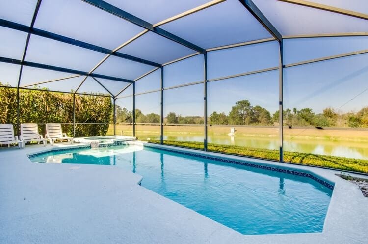 covered pool with view of field