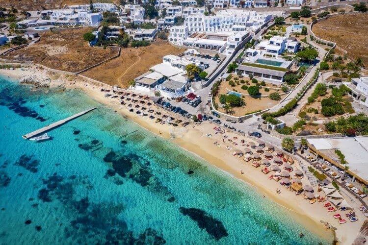 The busy resort town of Agios Ioannis Diakoftis with a white sandy beach and clear blue water