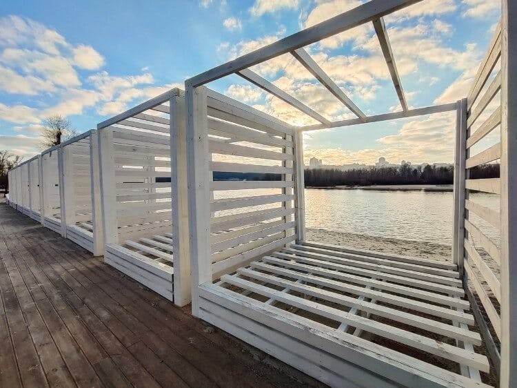 A stock image of riverfront wooden cabanas