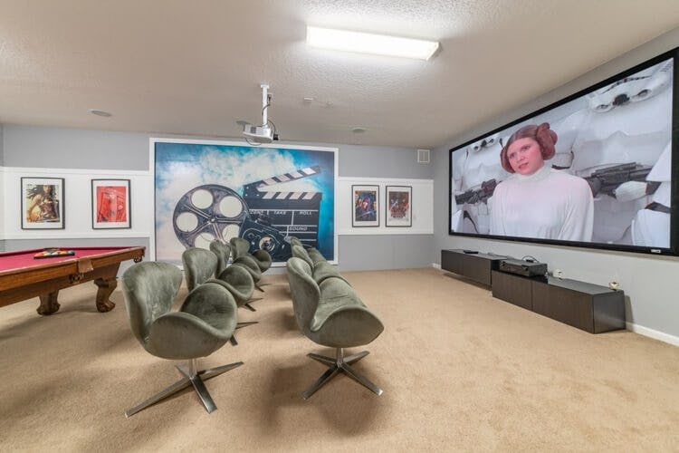 large home movie theater with big screen and pool table