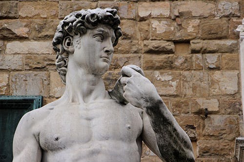 Close up of the head and torso of Michelangelo's David statue 