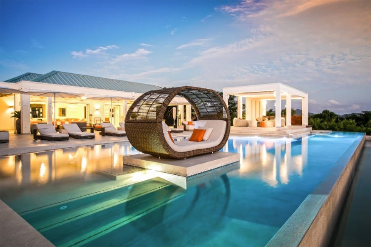 luxurious pool with lounger at dusk