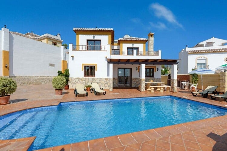 white and tan villa with patio and pool