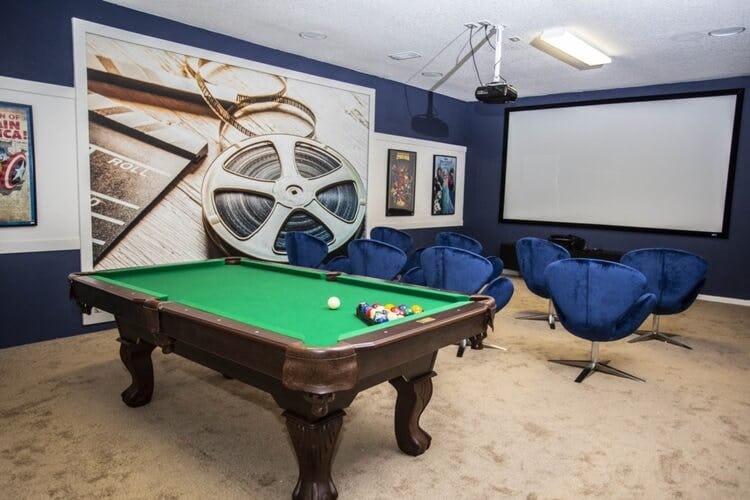 movie theater with blue seats and pool table