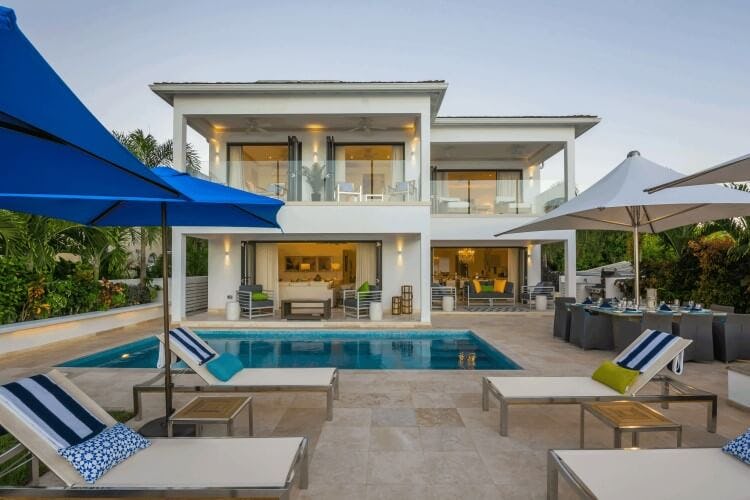 white villa with pool and loungers