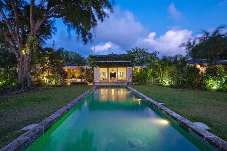 villa with long pool at dusk