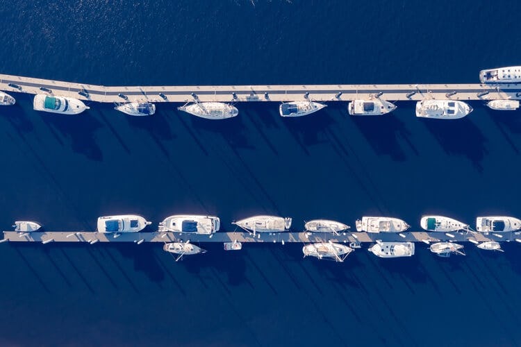 row of boats on a dock aerial view