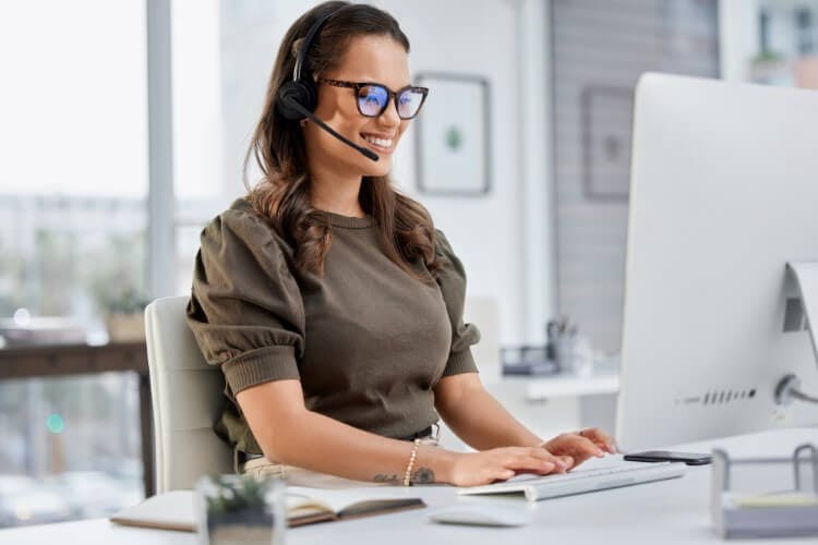 woman with headset on computer