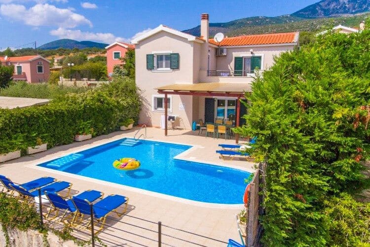 white villa with pool and yellow villa