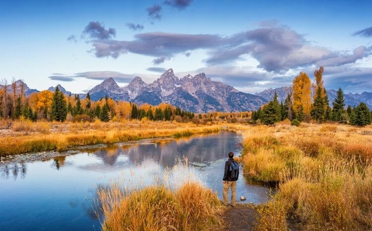 A man hiking in a USA national park during the fall