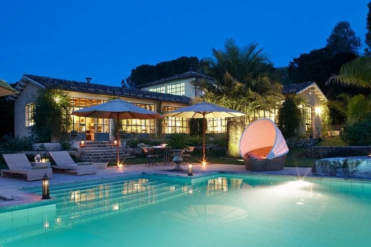 lit up villa and pool at dusk