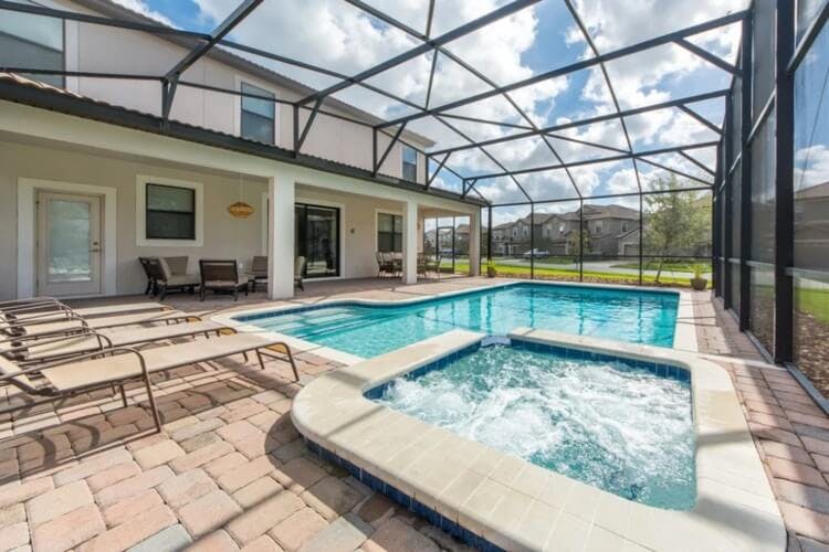 covered pool and hot tub with sun loungers