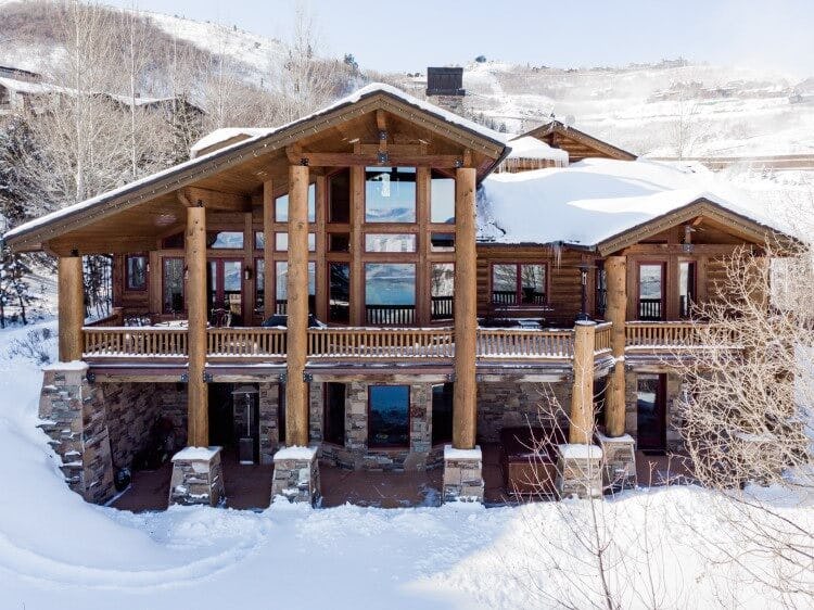 large cabin style manor in the snow