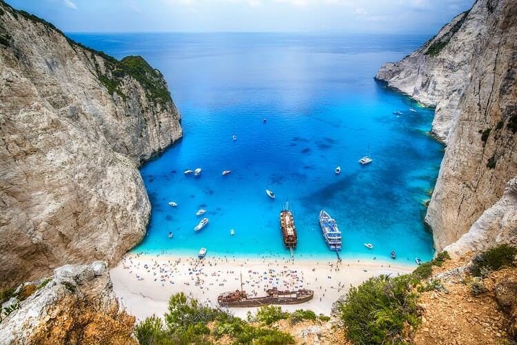 beach in zakynthos surrounded by cliffs