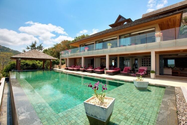 smart villa with red loungers and pool