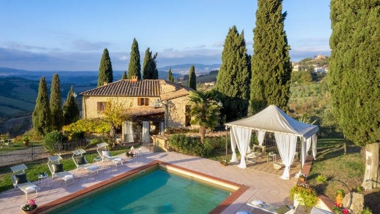 villa and pool with view over tuscan countryside