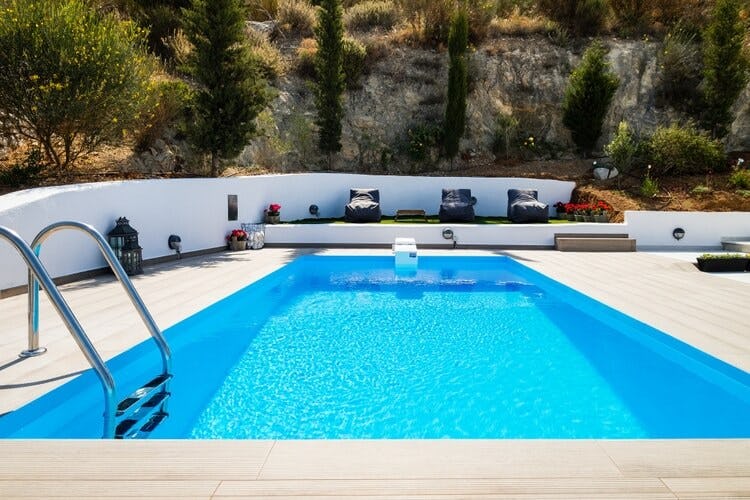 pool in deck with hill in background