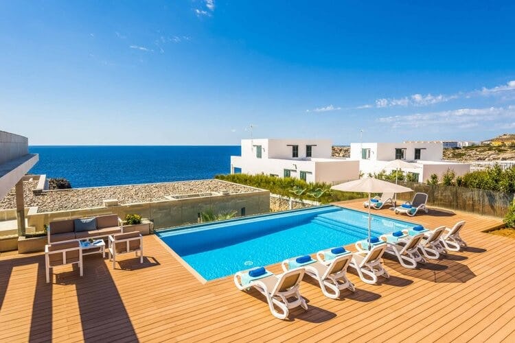 deck, loungers and pool overlooking ocean