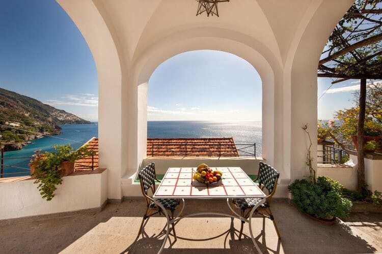 dining table on terrace overlooking ocean
