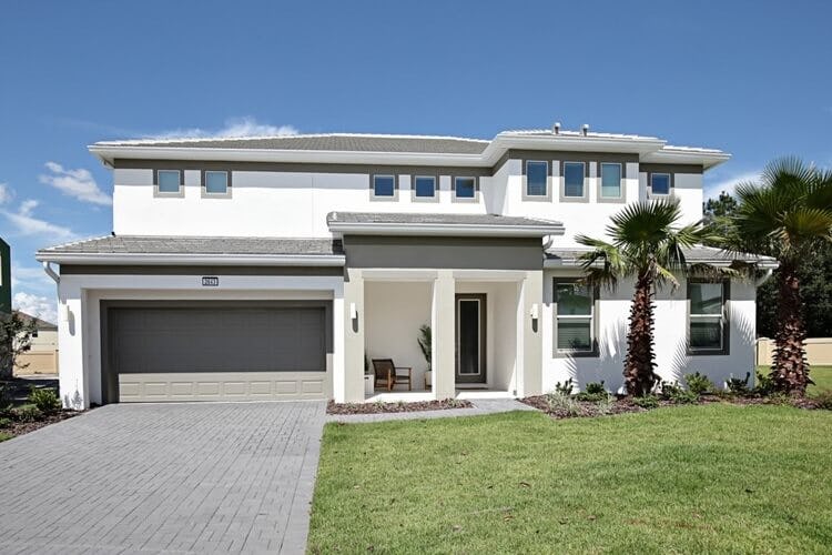 white villa with drive and lawn