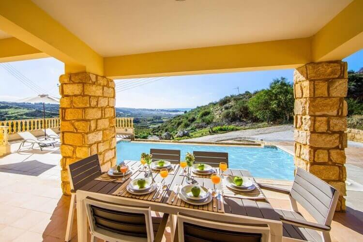 covered dining area overlooking pool