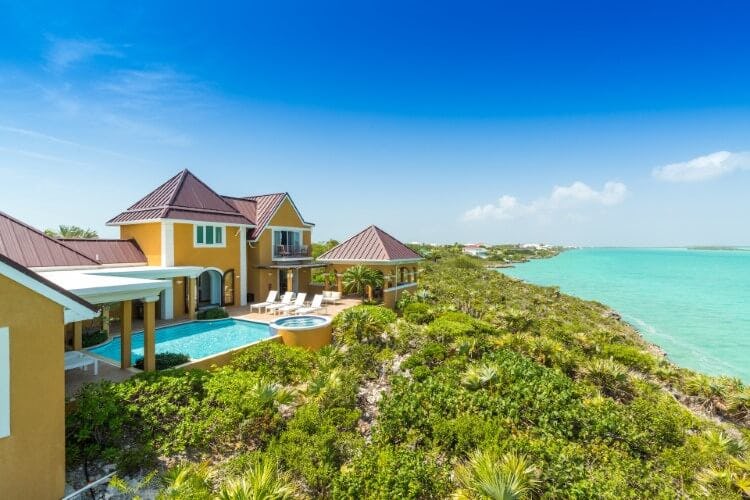 yellow villa with pool and villa overlooking ocean