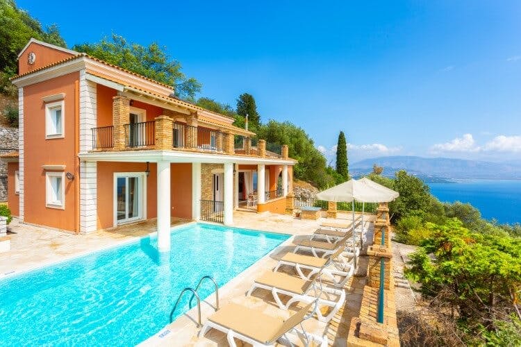 orange villa with pool overlooking sea