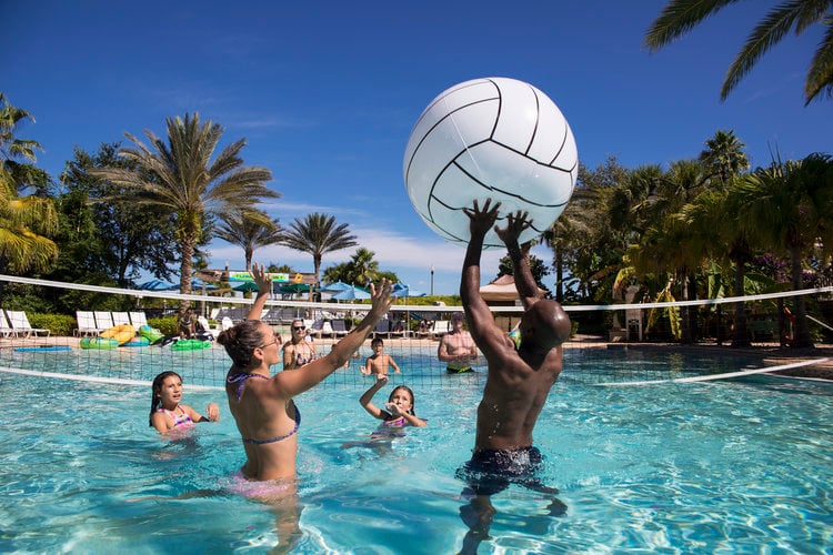People playing pool volleyball with a giant ball