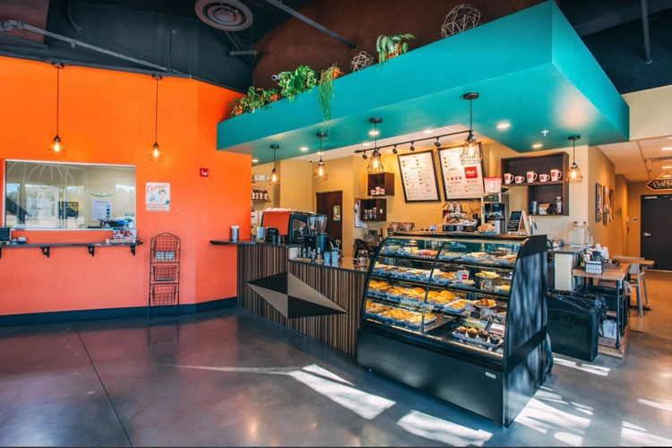 Axum Coffee Shop interior with orange walls and green counter