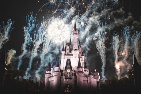 Disney World Castle lit by fireworks