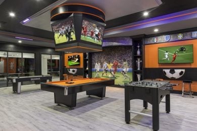 Sports themed game room with multiple TV screens