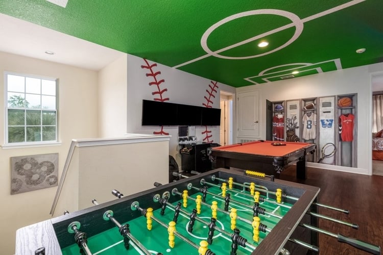 Game room with foosball table, pool table and locker room style artwork