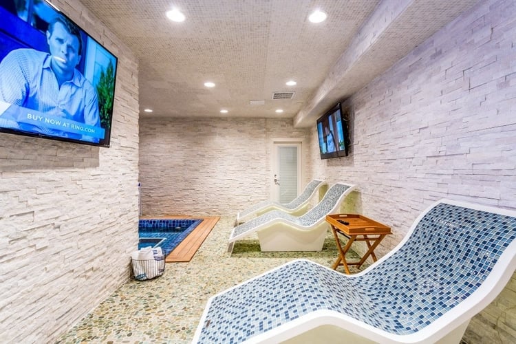 The spa in this villa features relaxing loungers and flat-screen TVs