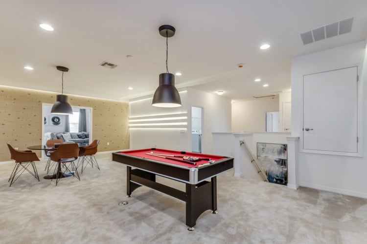 The first floor lounge in this villa has a cards table and a billiards table