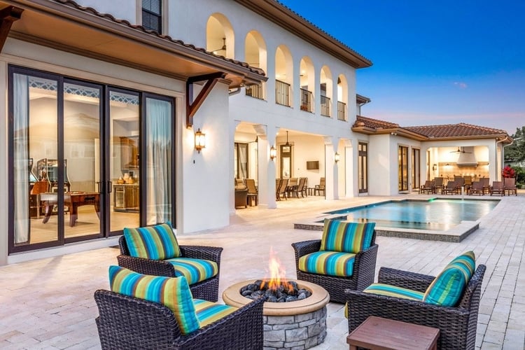 Outside there is a pool terrace with a fire pit, swimming pool and alfresco dining area