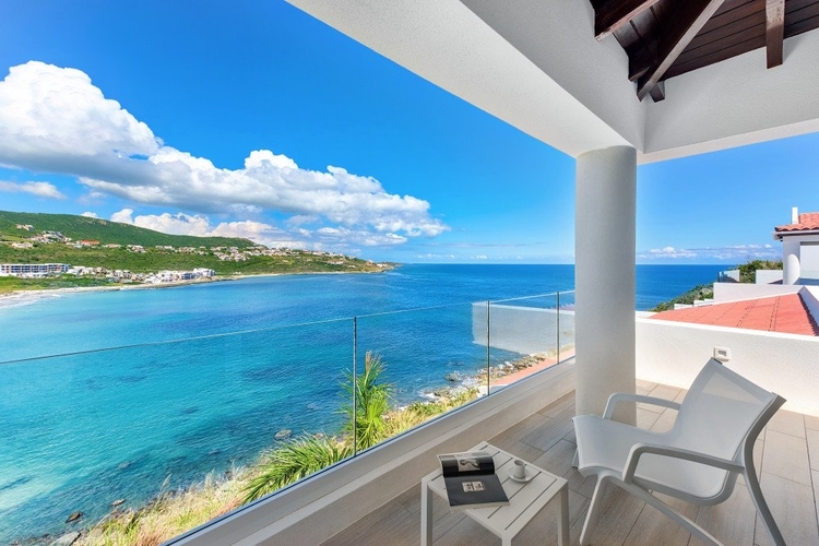 This villa has multiple balconies with lounge seating and sea views