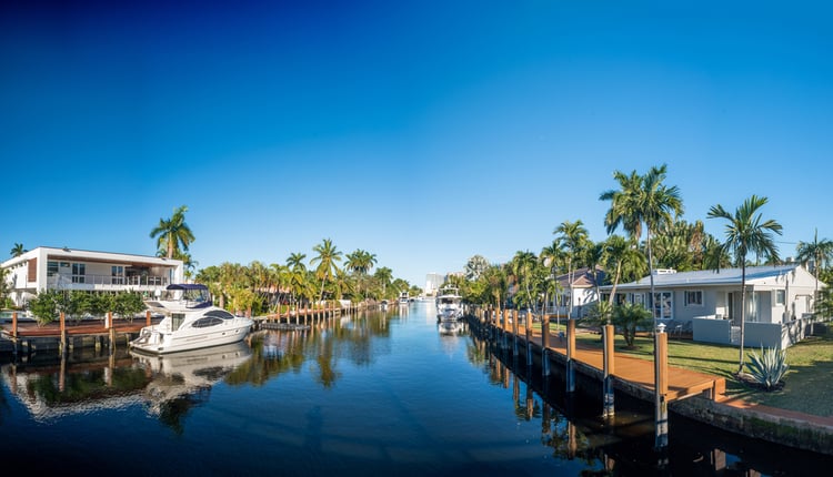 Cape Coral waterway with homes and moored up boats