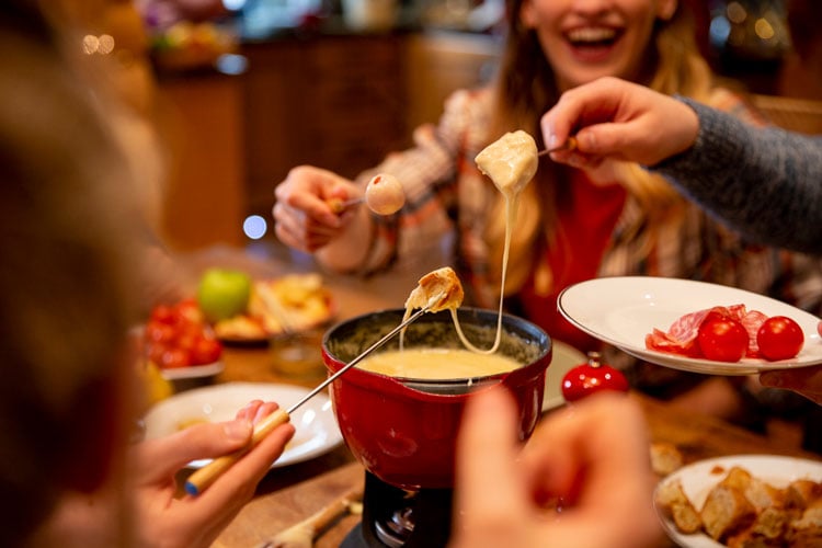 People enjoying cheese fondue