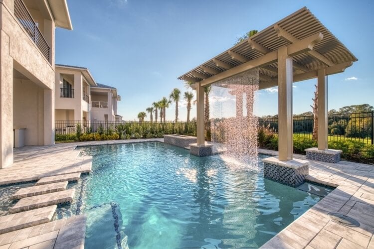 A private pool outside of a Florida villa with a waterfall feature